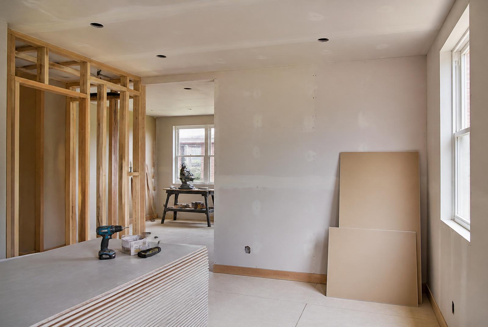 General building refurbishment interior with fresh plasterboard, stud framing and materials on site, Dorset